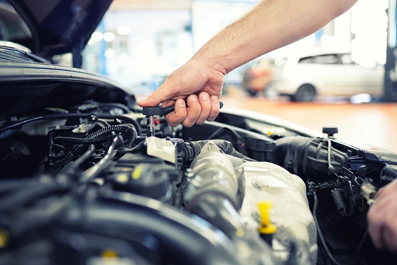 Mechanic working in a vehicle engine bay